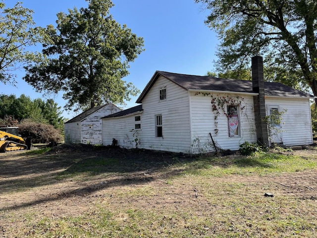 view of property exterior with a lawn