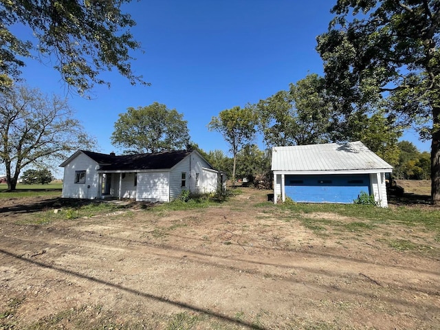 view of side of home with an outbuilding and a garage