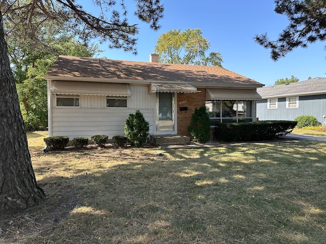 ranch-style home with a front lawn