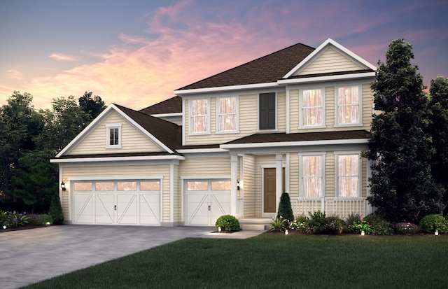 view of front of home featuring a garage and a lawn