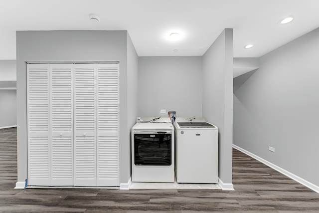 washroom with dark hardwood / wood-style floors and washer and dryer