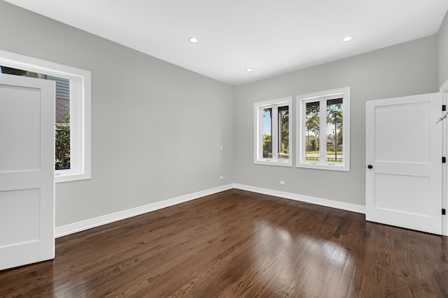 unfurnished room featuring dark hardwood / wood-style floors