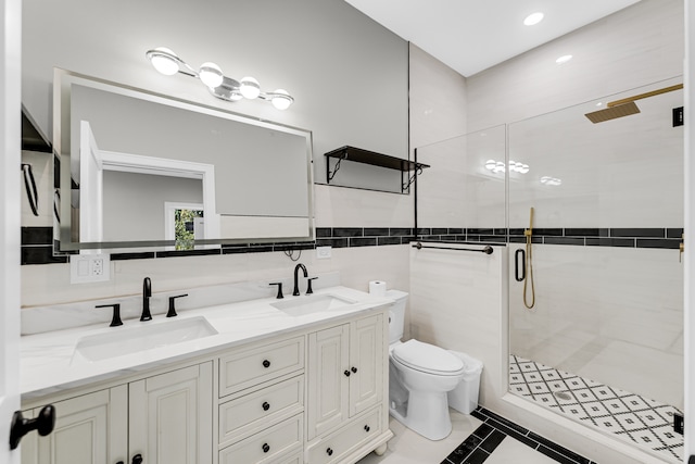 bathroom featuring walk in shower, vanity, tile walls, tile patterned flooring, and toilet