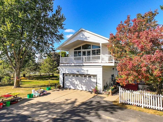 11971 W E Rd, Forreston, IL 61030 - view of front of home featuring concrete driveway, fence, an attached garage, and a balcony