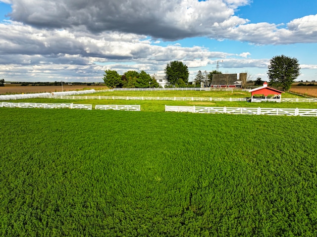 view of yard with a rural view and fence