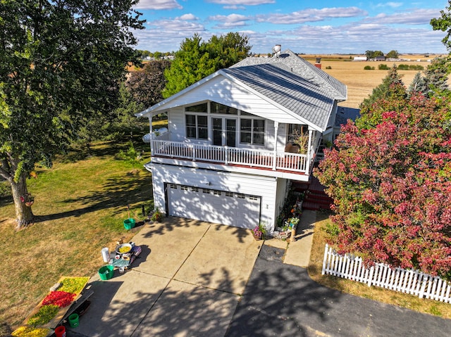 traditional-style house with concrete driveway, an attached garage, and a front yard