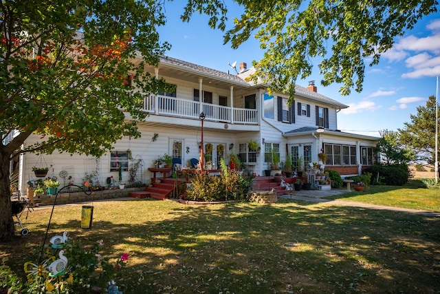11971 W E Rd, Forreston, IL 61030 - back of property with a balcony, french doors, a lawn, and a chimney