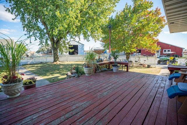 wooden terrace with a fenced backyard and a yard