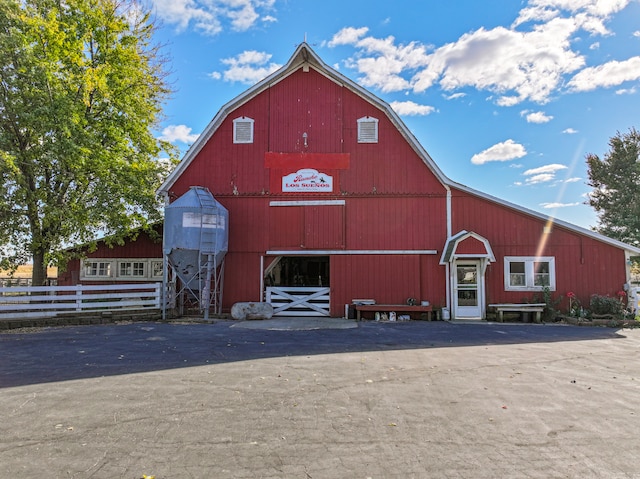 view of barn with fence