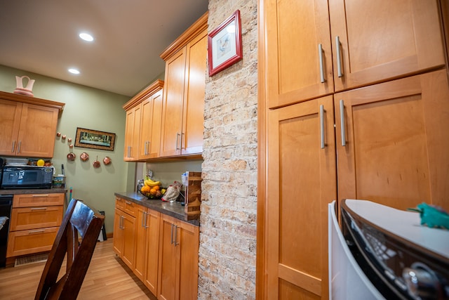 kitchen featuring dark countertops, stove, light wood-style floors, black microwave, and recessed lighting