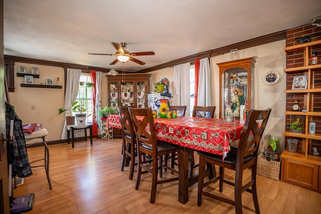 dining area with light wood-type flooring, baseboards, ornamental molding, and a ceiling fan