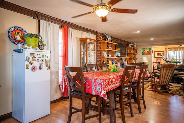 11971 W E Rd, Forreston, IL 61030 - dining space featuring ceiling fan, wood finished floors, recessed lighting, and crown molding