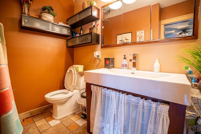 11971 W E Rd, Forreston, IL 61030 - bathroom with toilet, baseboards, and vanity