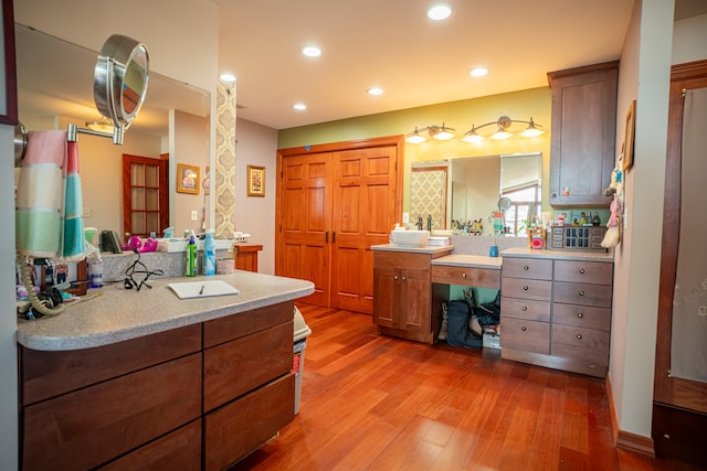 bathroom with vanity, wood finished floors, and recessed lighting