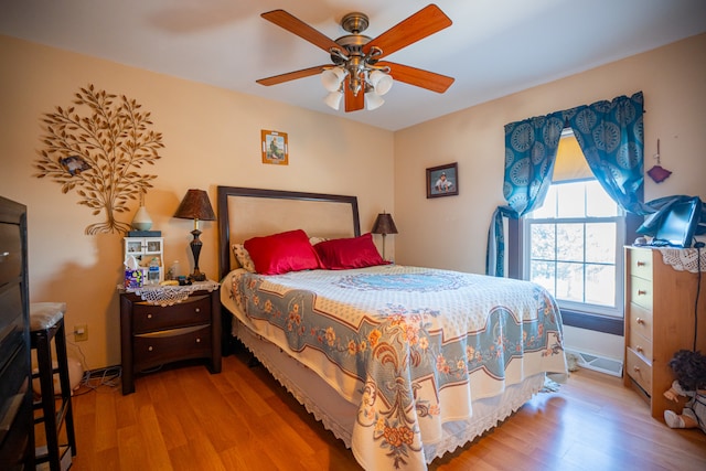 bedroom with ceiling fan and wood finished floors