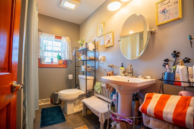 11971 W E Rd, Forreston, IL 61030 - bathroom featuring toilet and baseboards