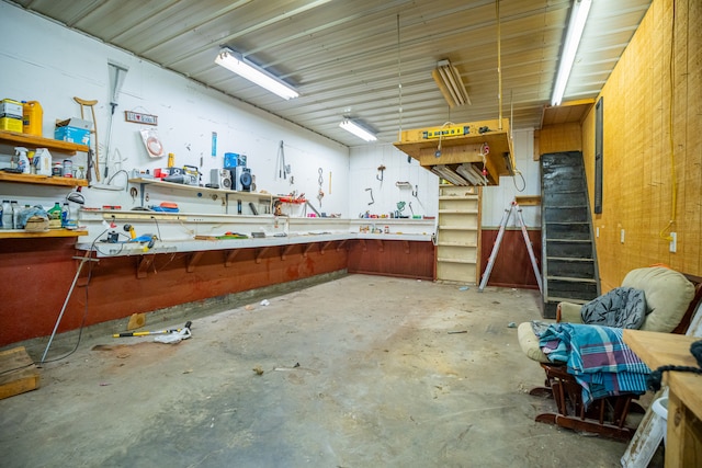 miscellaneous room featuring concrete flooring and a workshop area