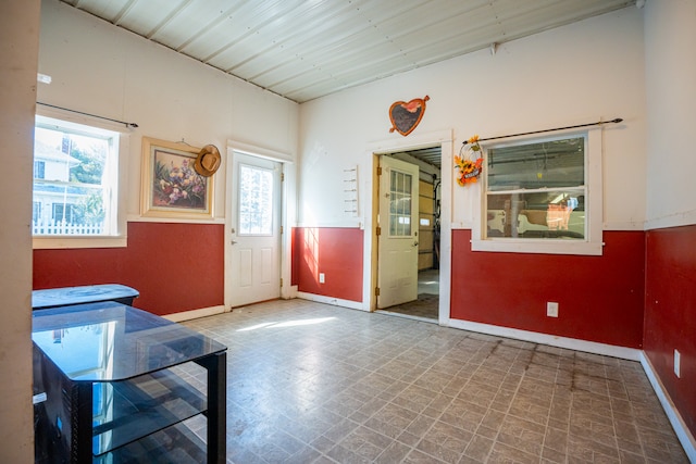 interior space with baseboards and tile patterned floors