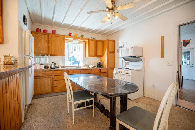 11971 W E Rd, Forreston, IL 61030 - kitchen featuring white appliances, a ceiling fan, brown cabinetry, and a sink