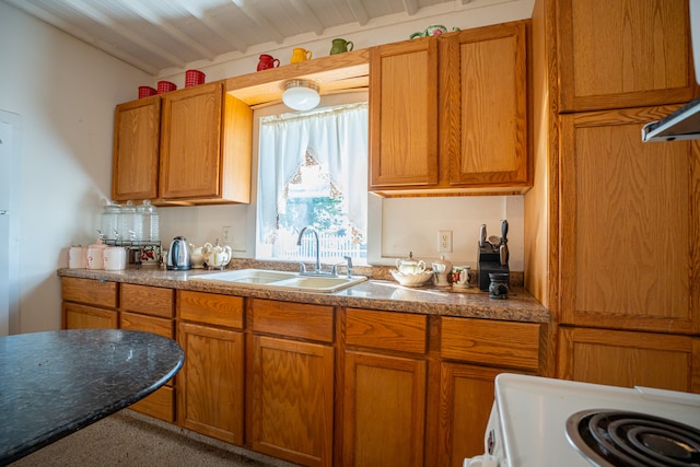 kitchen featuring lofted ceiling, brown cabinets, a sink, and white electric stove