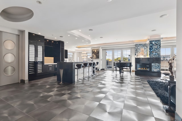 kitchen with a breakfast bar area and a tray ceiling