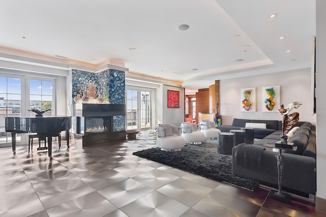 living room with a wealth of natural light and a raised ceiling