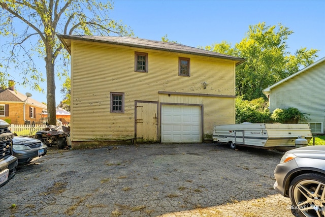 rear view of property with a garage