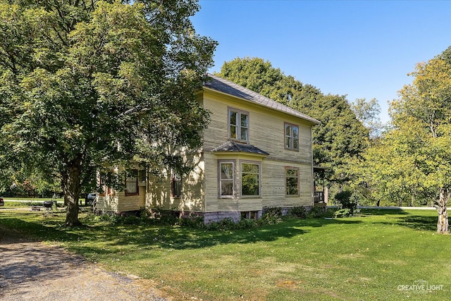 view of side of property with a yard