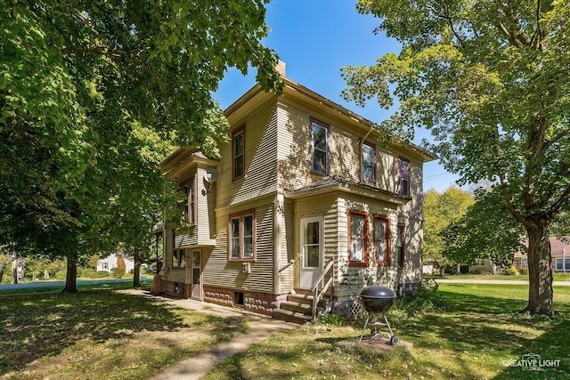 view of property exterior featuring a lawn