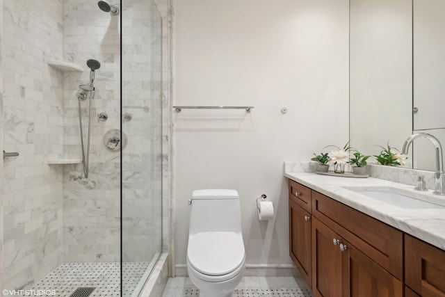 bathroom with tile patterned floors, vanity, toilet, and a shower with shower door