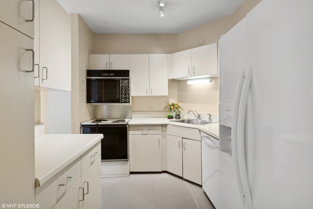 kitchen featuring white appliances, sink, a textured ceiling, and white cabinetry