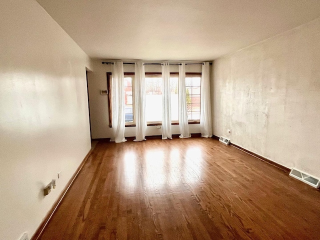 unfurnished room with hardwood / wood-style floors