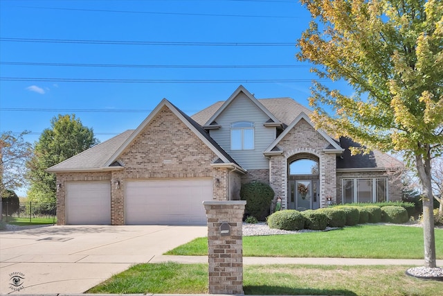 view of front of property featuring a front lawn and a garage