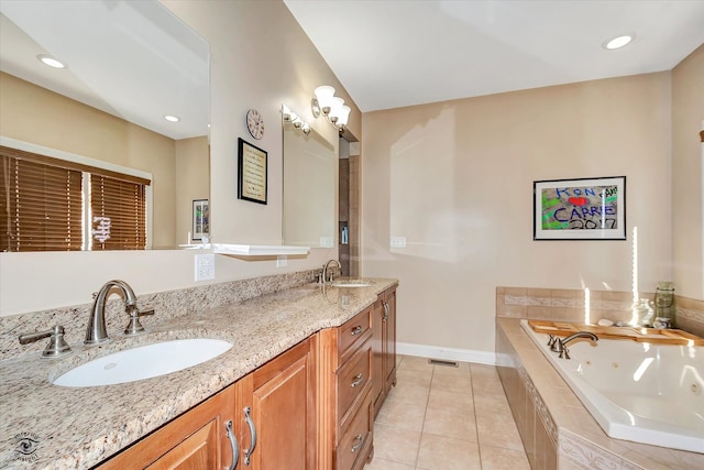 bathroom featuring tiled bath, tile patterned floors, and vanity