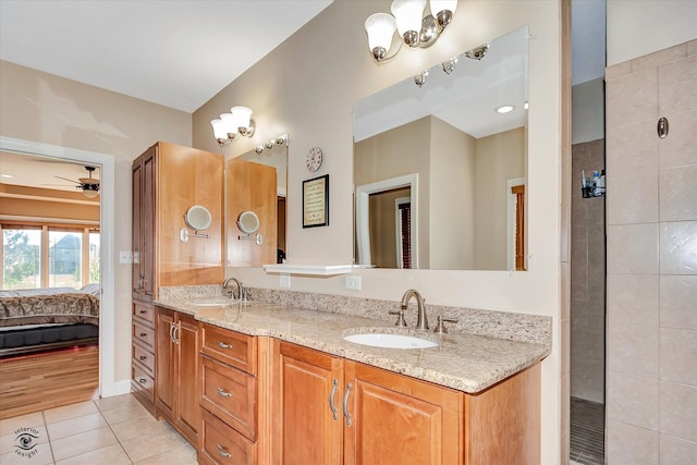 bathroom with ceiling fan, tile patterned flooring, and vanity