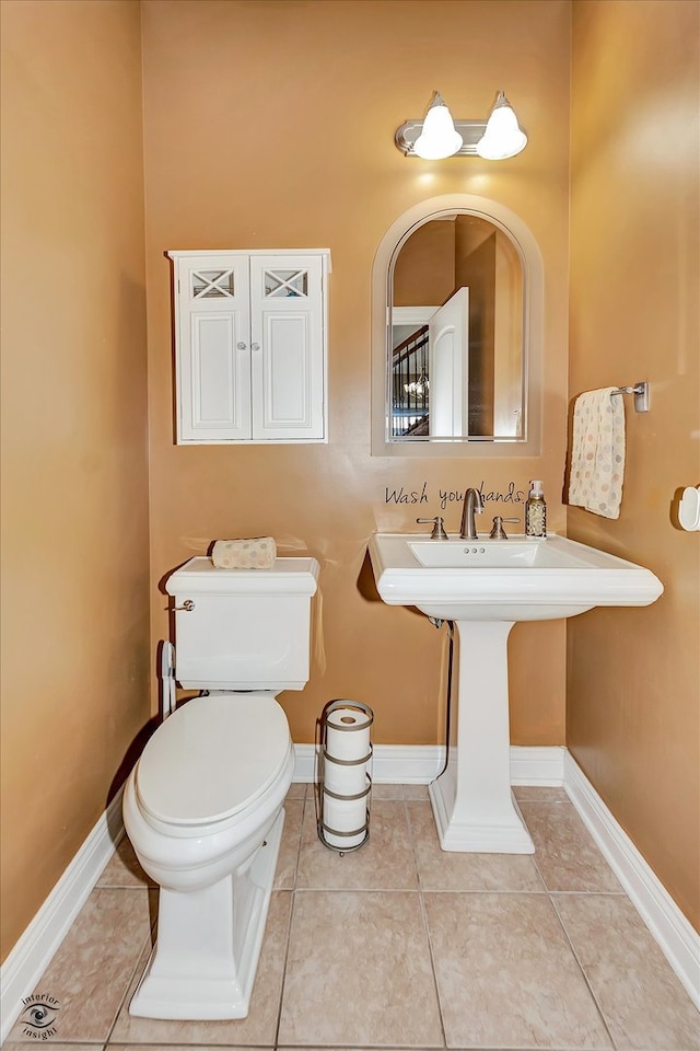 bathroom with tile patterned flooring and toilet