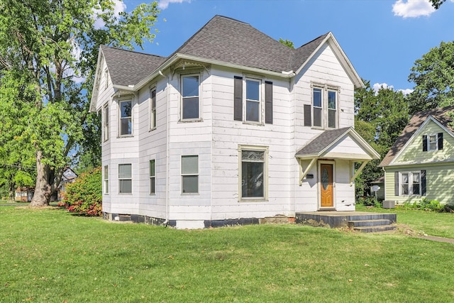 view of front of home featuring a front yard and central AC unit