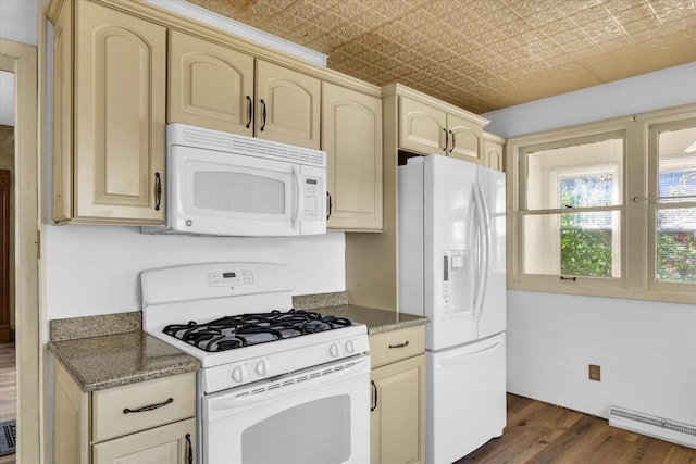 kitchen featuring white appliances, light brown cabinetry, baseboard heating, dark hardwood / wood-style flooring, and dark stone countertops