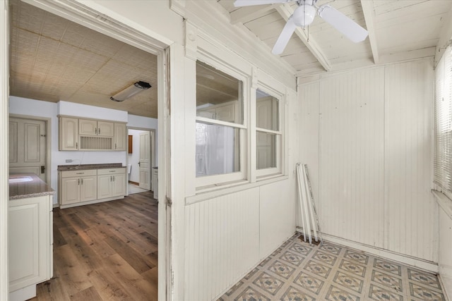 interior space featuring beam ceiling and ceiling fan