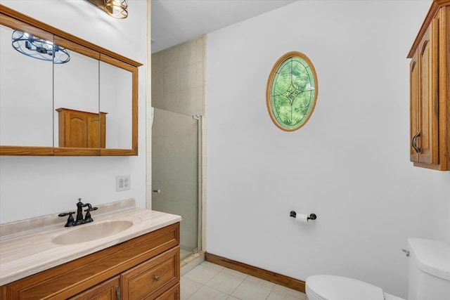 bathroom with tile patterned floors, a shower with shower door, vanity, and toilet