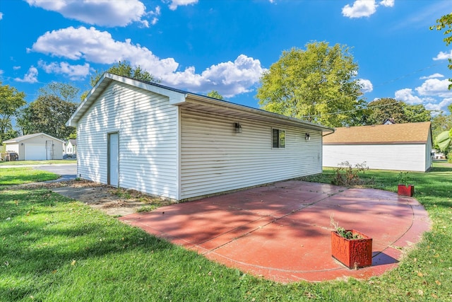 view of outdoor structure featuring a lawn and a garage