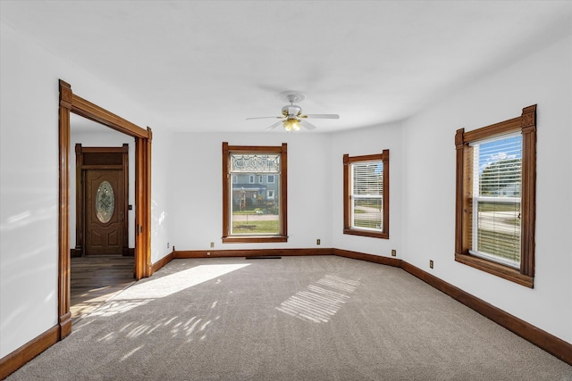 unfurnished room featuring carpet floors, plenty of natural light, and ceiling fan