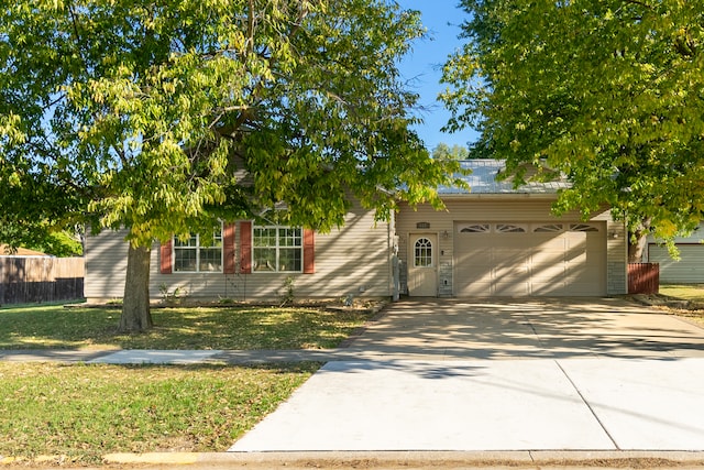 view of front of house featuring a front lawn and a garage