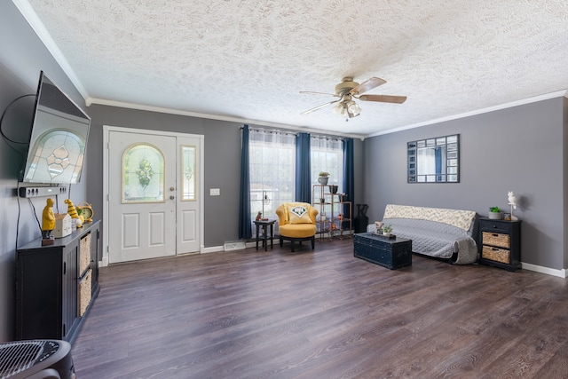 interior space featuring ceiling fan, ornamental molding, a textured ceiling, and dark hardwood / wood-style flooring