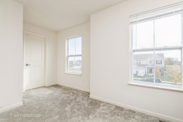 empty room with light colored carpet