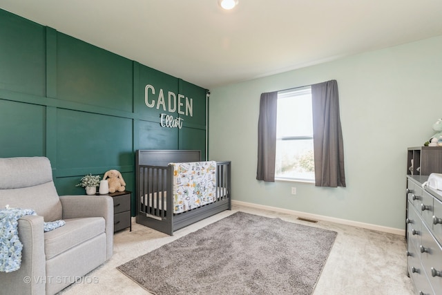 carpeted bedroom with a crib