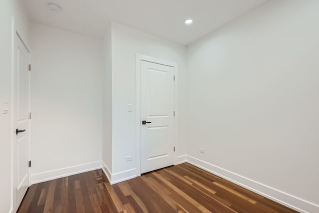 spare room featuring dark wood-type flooring