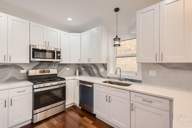 8513 S Maryland Ave, Chicago, IL 60619 - kitchen featuring appliances with stainless steel finishes, a sink, and white cabinetry