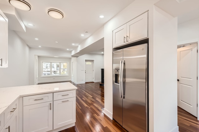 kitchen featuring white cabinetry, light stone counters, stainless steel fridge with ice dispenser, and dark hardwood / wood-style flooring