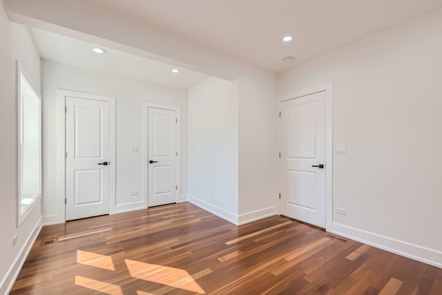 unfurnished bedroom with dark hardwood / wood-style floors